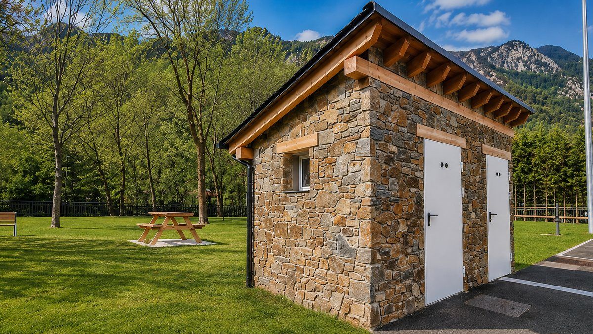 Stone toilet block and green area at the Canrodes motorhome area, Andorra